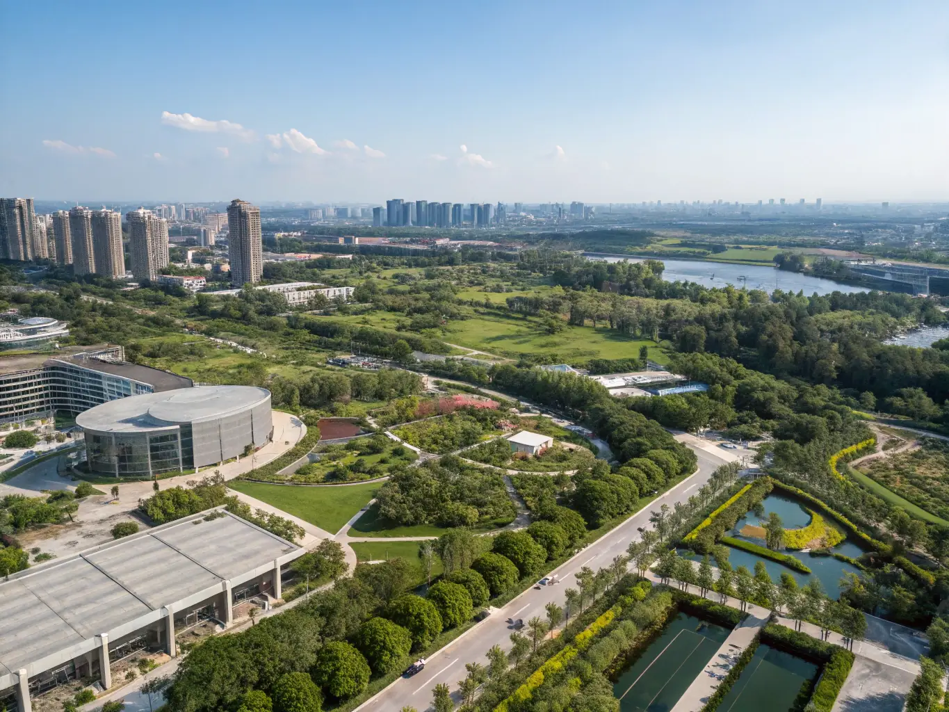 An aerial view of a city showcasing green infrastructure and sustainable urban development projects, highlighting environmental consulting services.