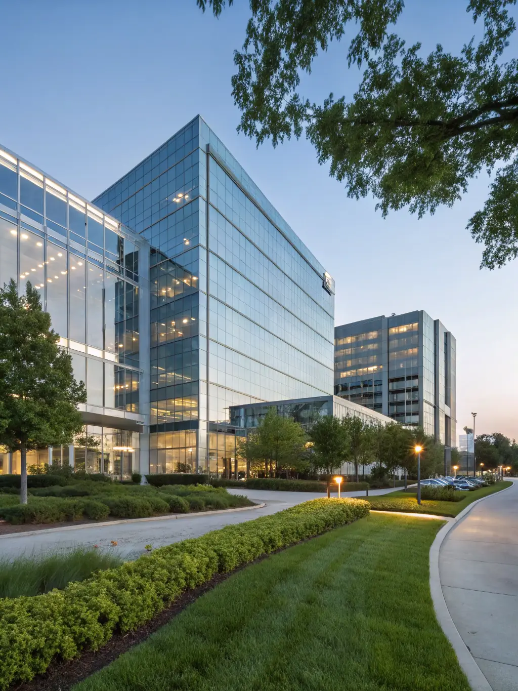 A modern office building with a 'For Sale' sign, representing real estate and franchise development services.